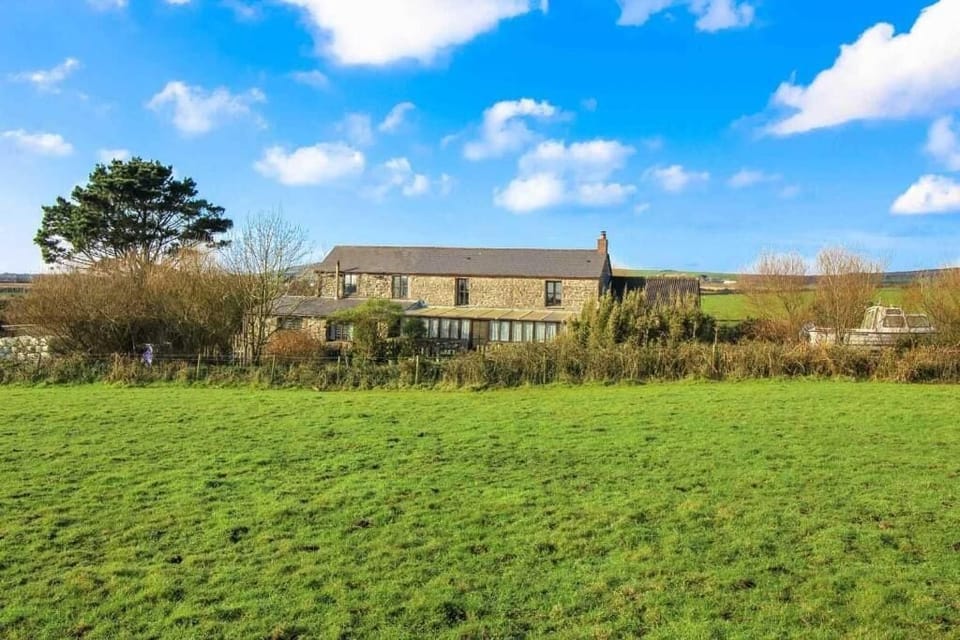 The cottage is surrounded by open  countryside 