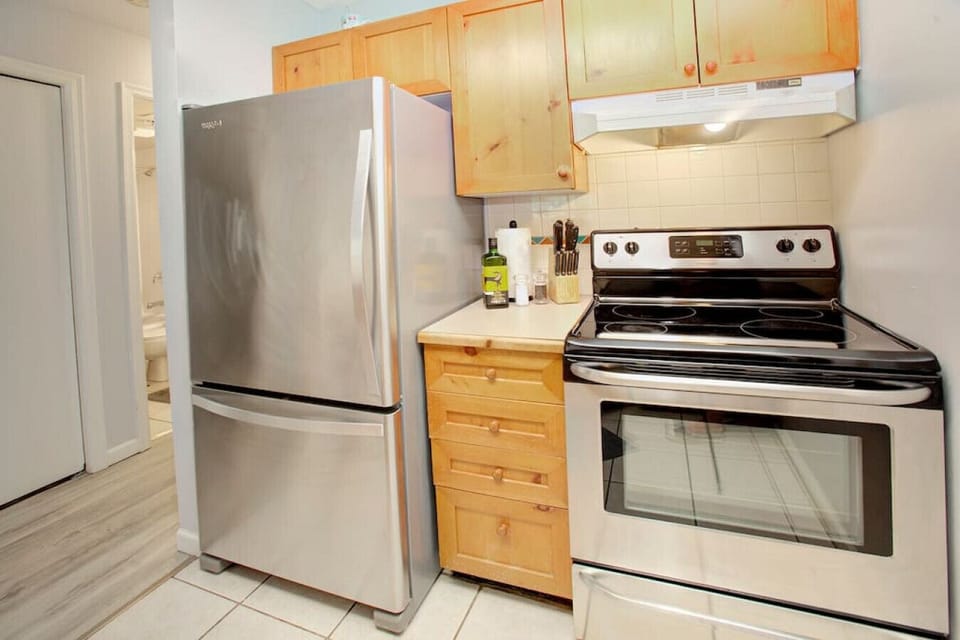 Large Fridge, and other appliances including: Toaster, microwave, oven, stove, kettle, coffee maker & more.