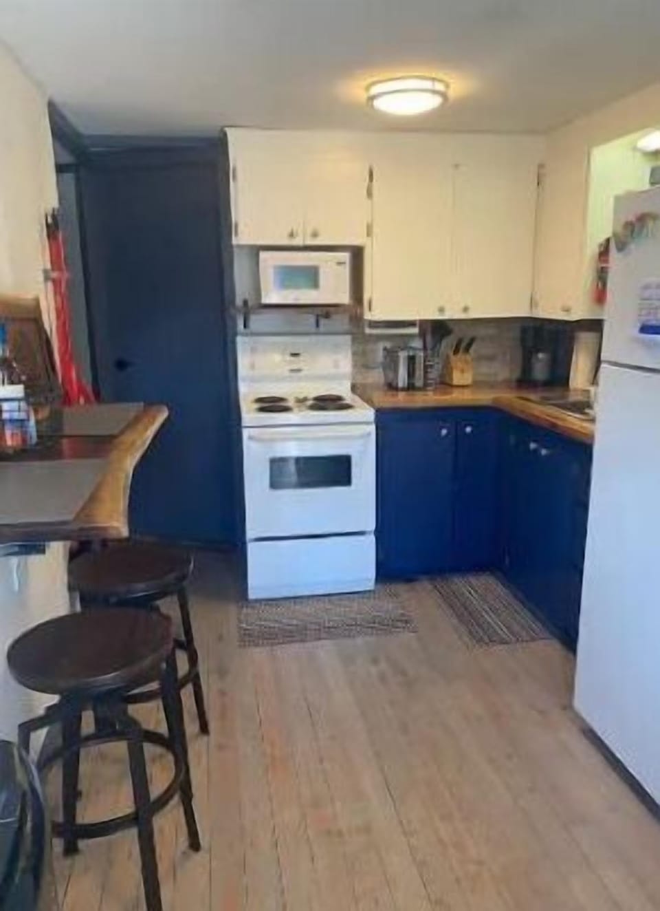 Kitchen c/w fridge, stove and banquet.
