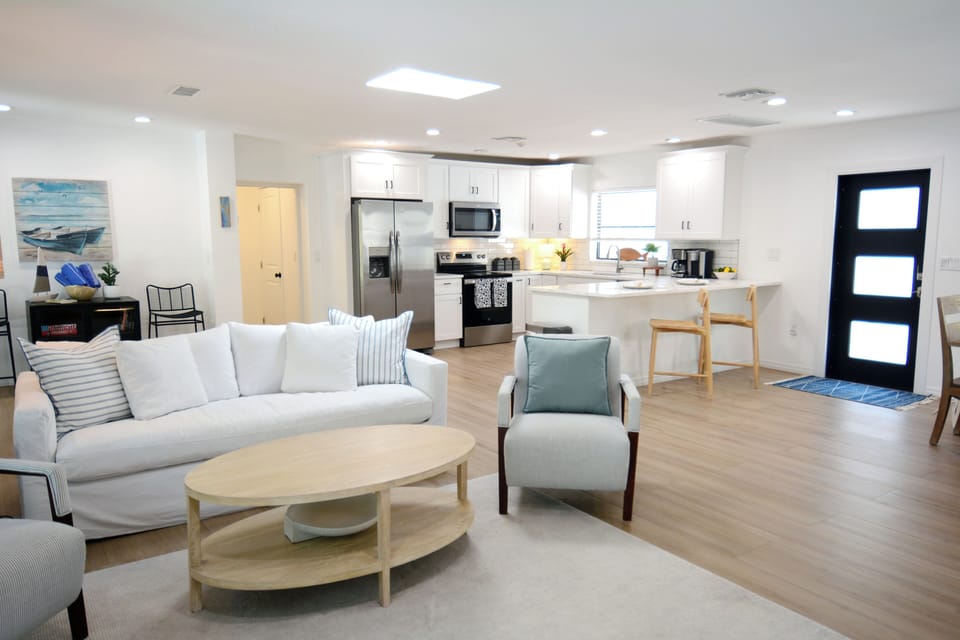 Large open concept floor plan with skylight, smart TV, pool and patio access