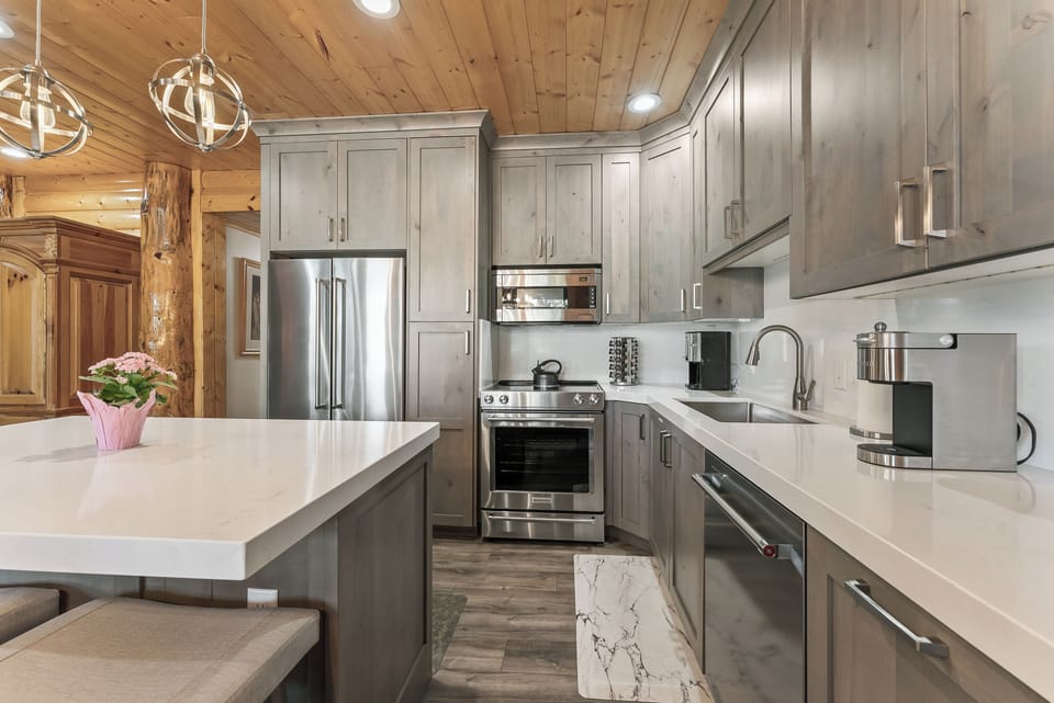 - Sleek kitchen with stainless steel appliances and island  
- Ample counter space for meal prep and modern lighting  
- Perfect for cooking and entertaining during your stay