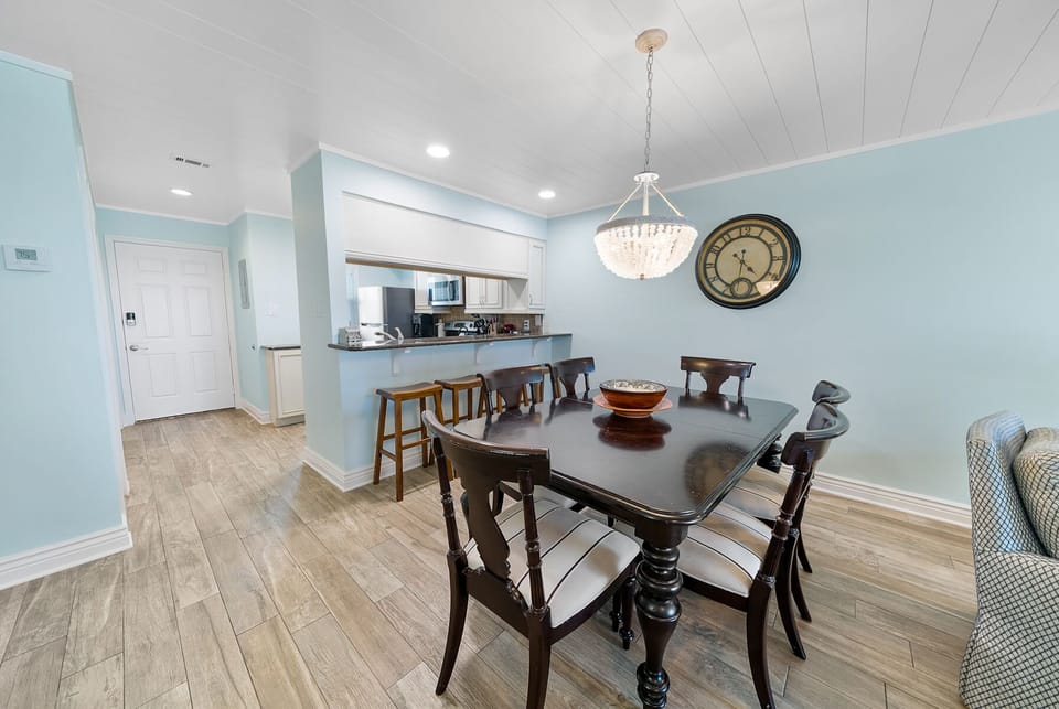 Gather around your elegant dining table for memorable meals while the chandelier casts warm light over conversations that'll last long into the evening.