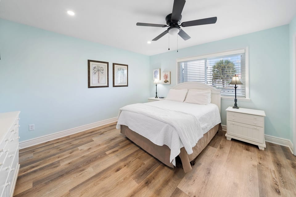 Rest peacefully in your serene bedroom with soothing coastal colors, comfy linens, and gentle ceiling fan breeze.
