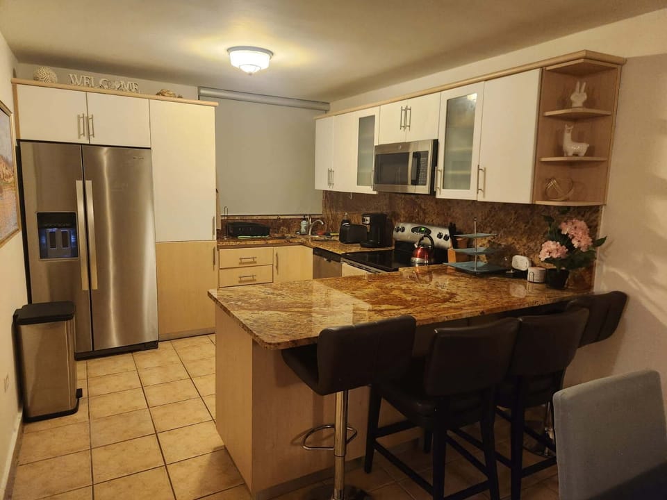 Kitchen at night: now also showing 4 stools, toaster, kettle and new trash can