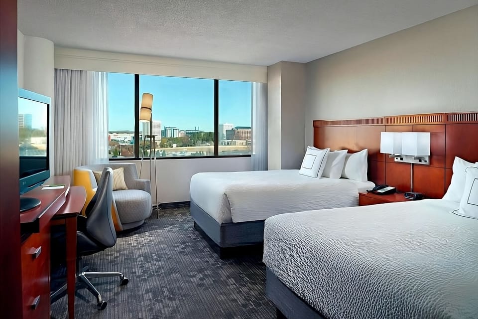 Spread out in two queen beds with skyline views beyond.