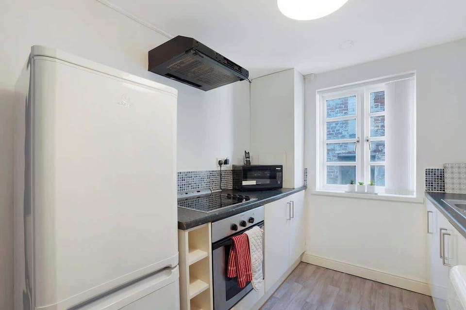 Kitchen equipped with all essentials, including a washer & dryer, oven, fridge and full cookware set.