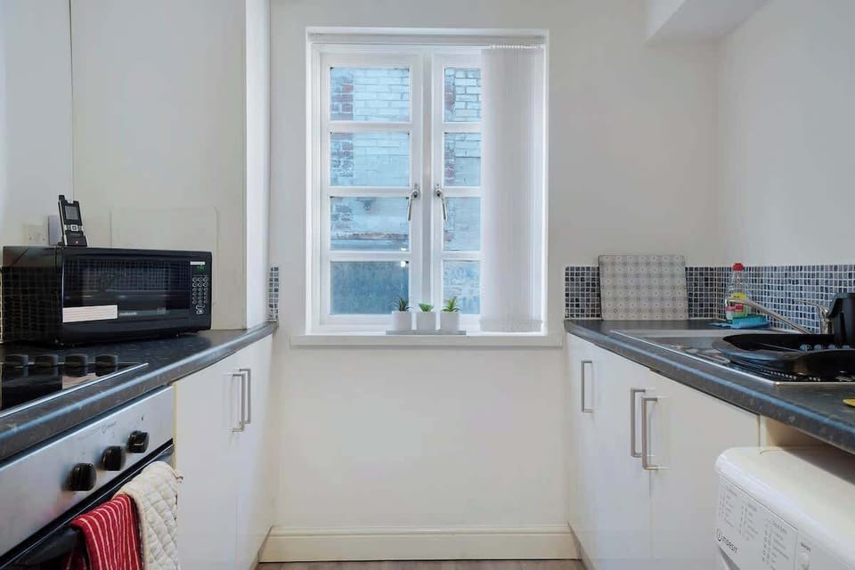 Kitchen equipped with all essentials, including a washer & dryer, oven, fridge and full cookware set.