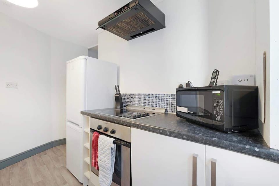 Kitchen equipped with all essentials, including a washer & dryer, oven, fridge and full cookware set.