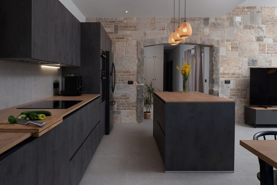 A dining table for 6 people a kitchen island with two bar stools, all with direct exits toward the pool area