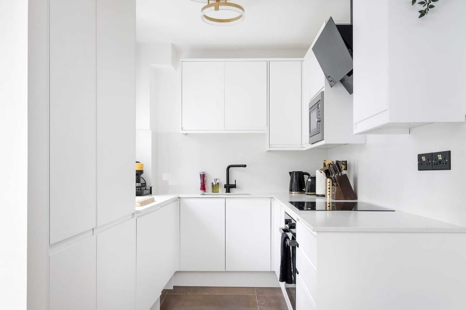 A symphony of clean lines and sleek surfaces, this modern kitchen is a minimalist's dream, offering both visual appeal and high functionality for culinary enthusiasts