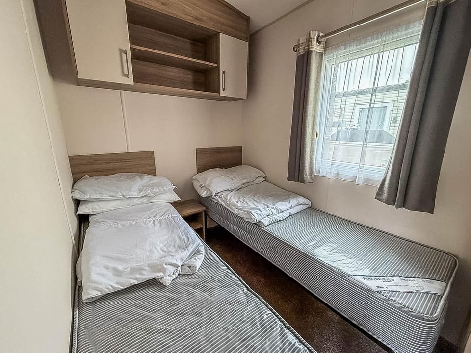 Cozy twin bedroom with natural light and smart storage