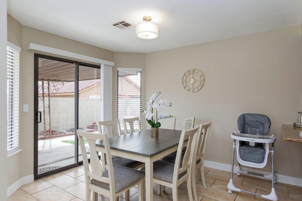 Spacious dining area sits six and high chair for kids.