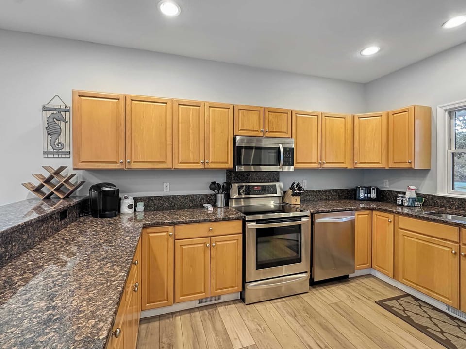 Main Level: Spacious Kitchen w/ Granite Countertops, Stainless Steel Appliances, Ample Cabinet Storage, and Recessed Lighting