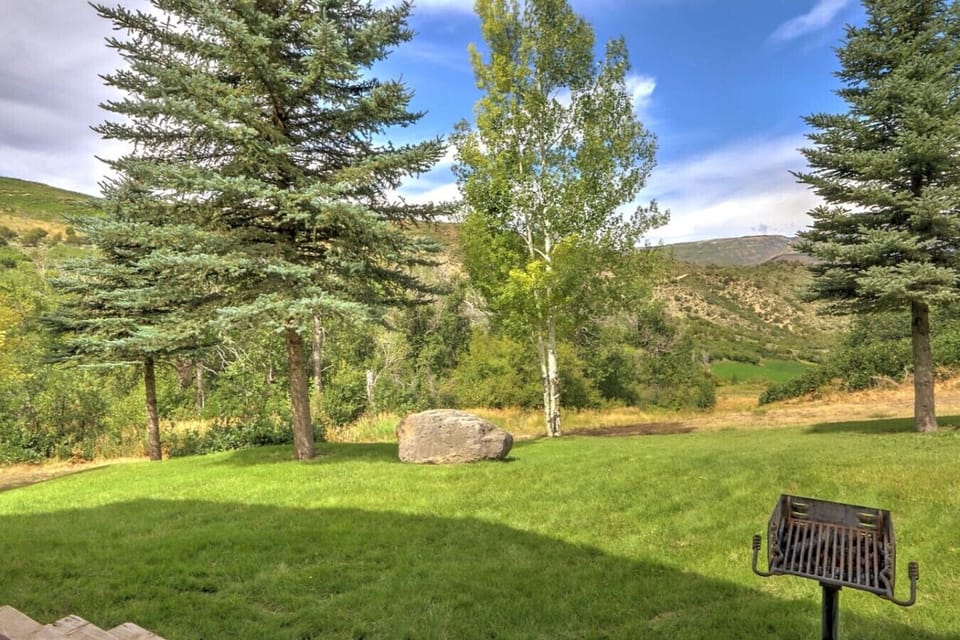 Charcoal grill in front of cabin