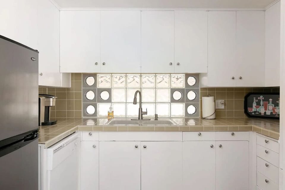 Fully stocked kitchen with pots, pans, eating utensils