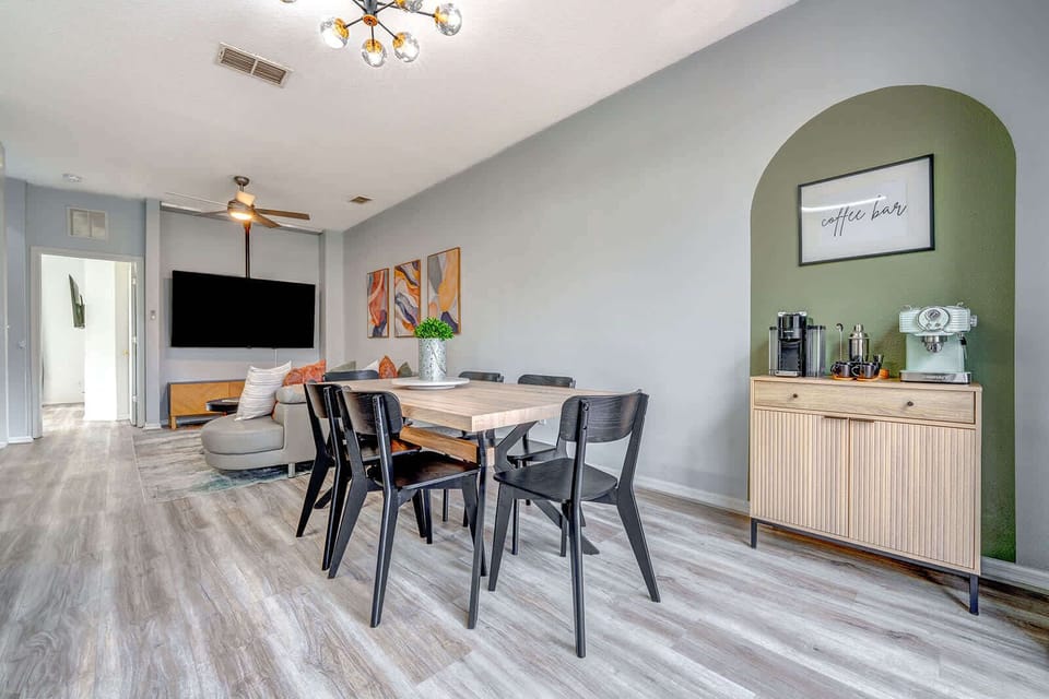 Modern dining area with a dedicated coffee bar and comfortable seating for six.