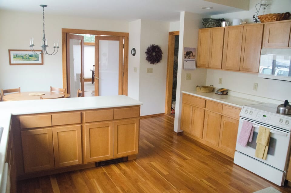 Kitchen with circular dining table area.  Door into dining room.