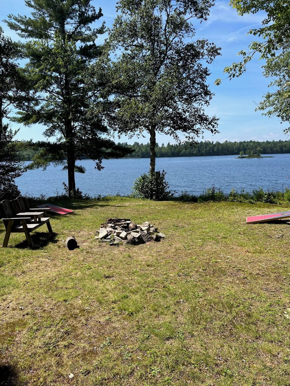 Fire pit, grill, horseshoes, croquet set, and corn hole in yard