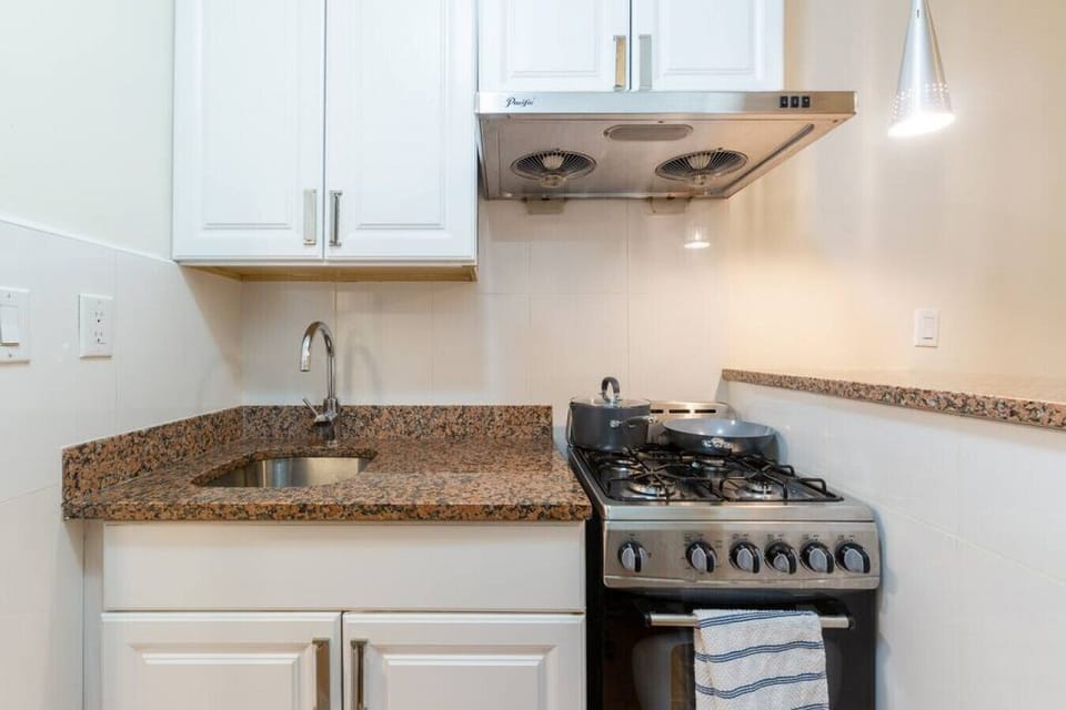 Convenient and practical kitchen has as stove and cooktop.