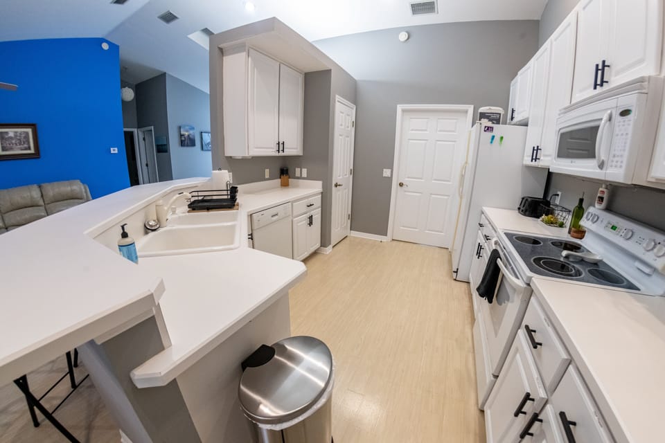 The kitchen is well stocked with essentials for cooking.