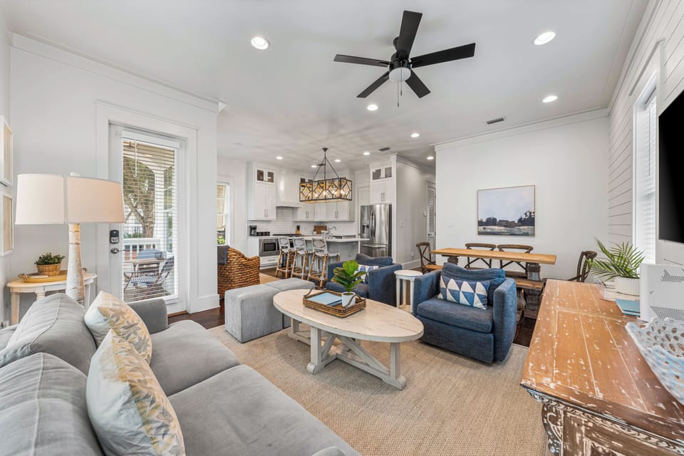 Bright coastal living room with plush seating, airy windows, and relaxed beach-house style.
