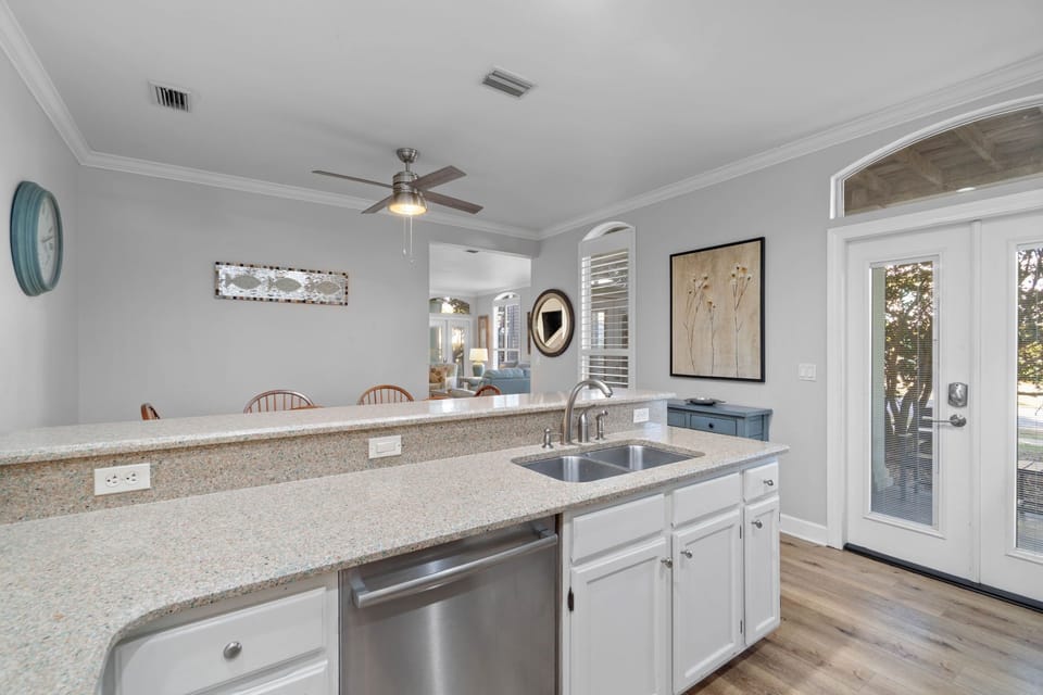 The open well-stocked kitchen leads to the outdoor grill area