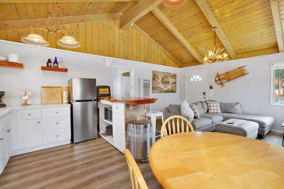 Fully equipped cabin kitchen with ample cabinetry, stove, fridge, and a coffee maker—perfect for cooking meals, morning coffee, and feeling right at home on your stay.
