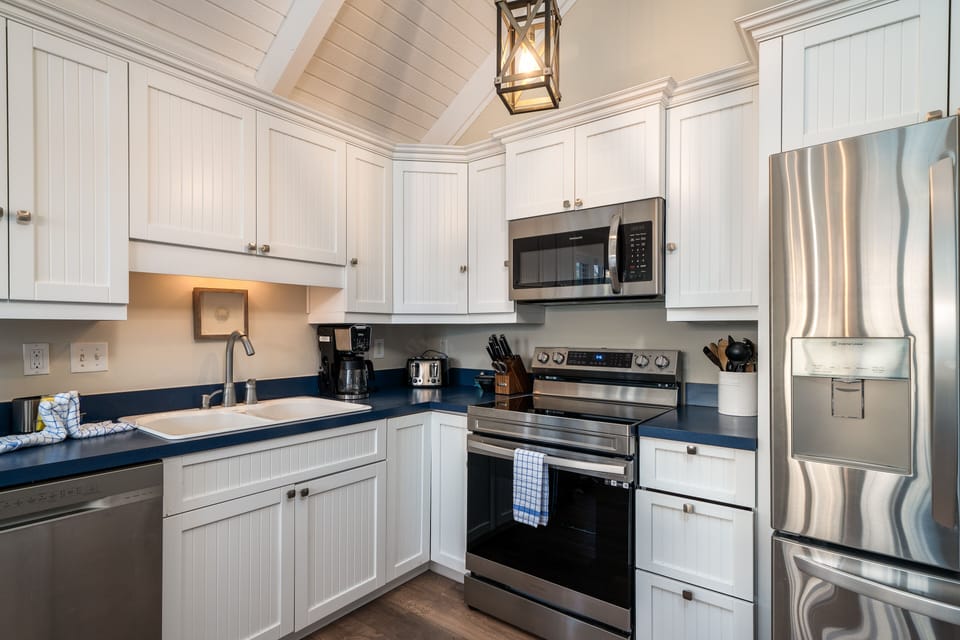 The kitchen has wainscot cabinets, new flooring & appliances, and is very open.