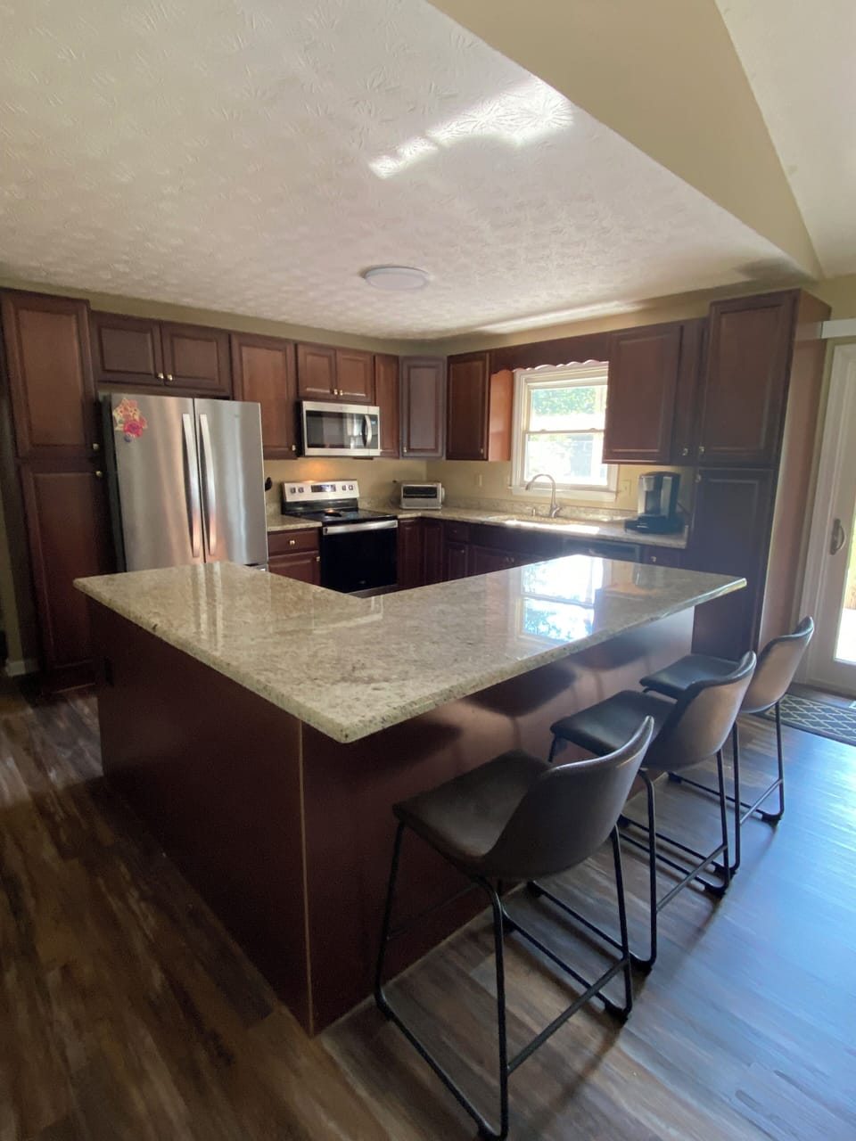 Fully stocked kitchen with new cabinets and stainless appliances.