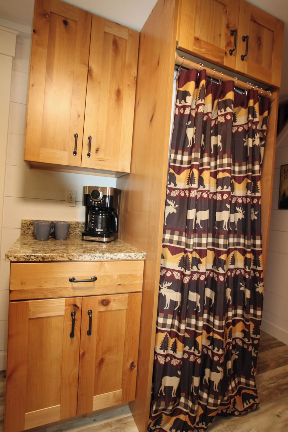 Coffee maker. Washer and dryer behind curtain 