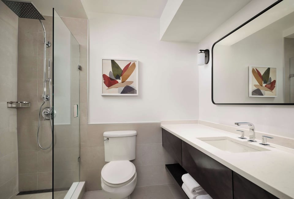 Refresh under a rainfall shower in a spotless modern bath