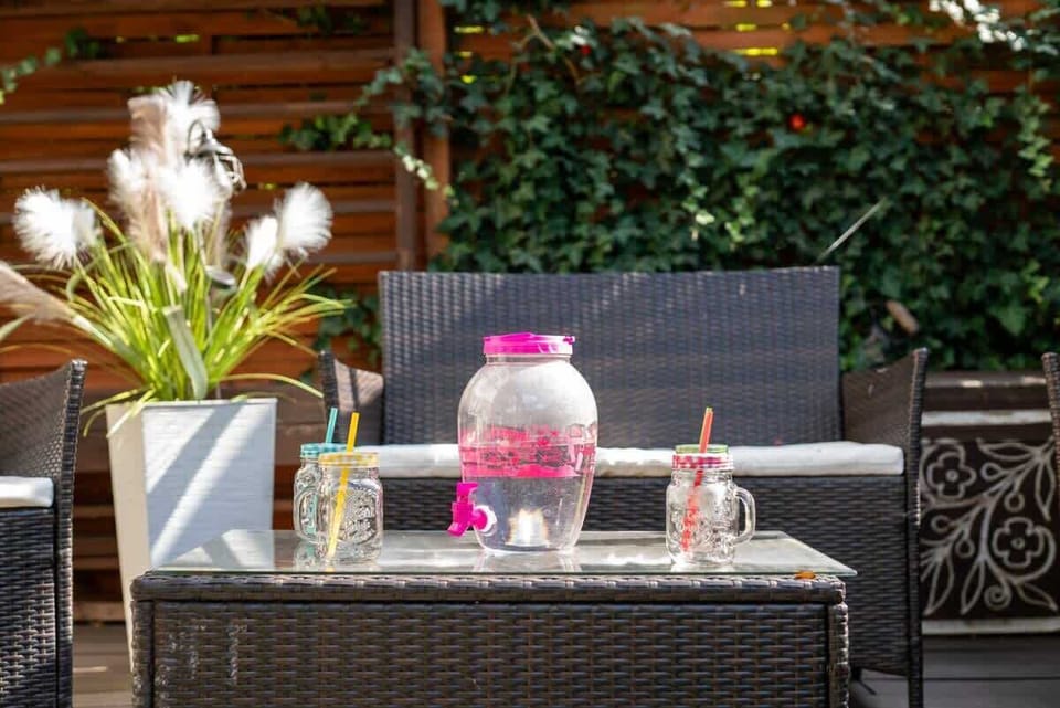 A detailed view of the patio table with decorative lanterns, flowers, and modern outdoor styling.


