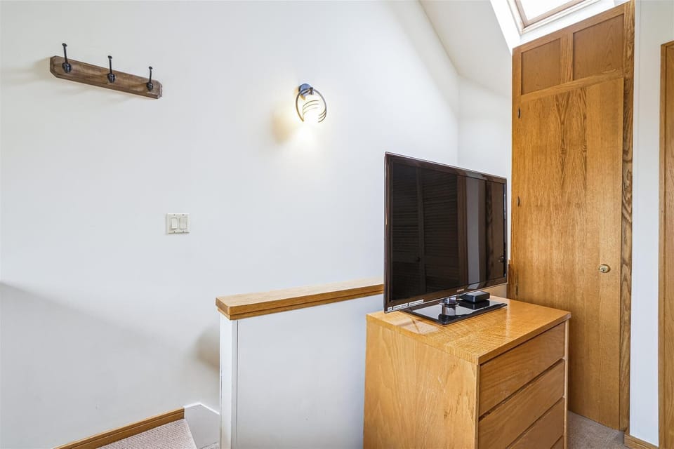 Loft sleeping area with king bed and attached bedroom