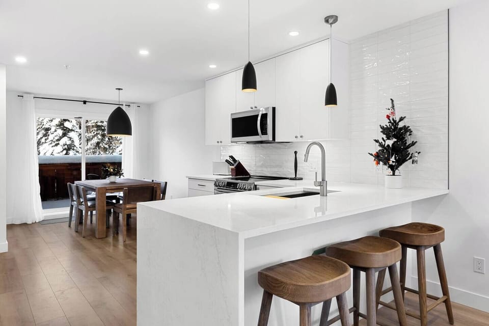 The modern designed kitchen is complete with a high-end dining table and chairs that seat 6 people.