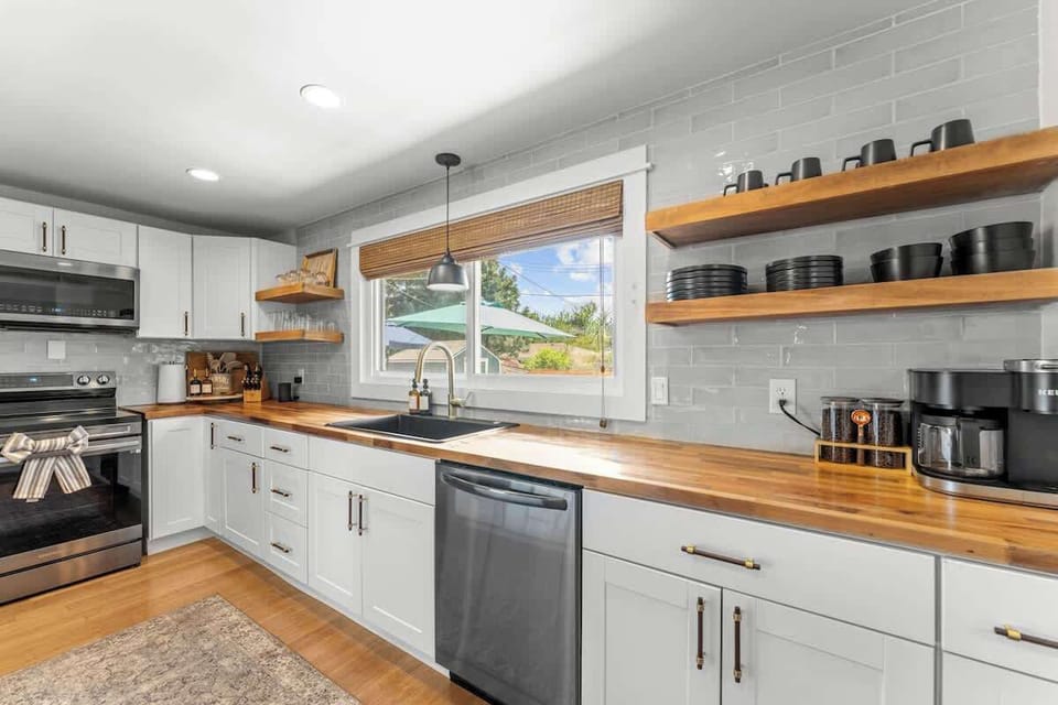 Kitchen (complementary bottle of wine, welcome guide, stainless steel appliances, butcher block island with four chairs, fully stocked with all cooking essentials)