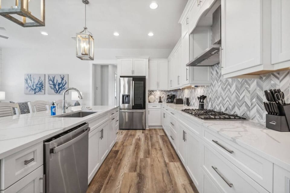 Fully-Stocked Kitchen with Tile Backsplash, Stainless Steel Appliances and Island Bar Seating