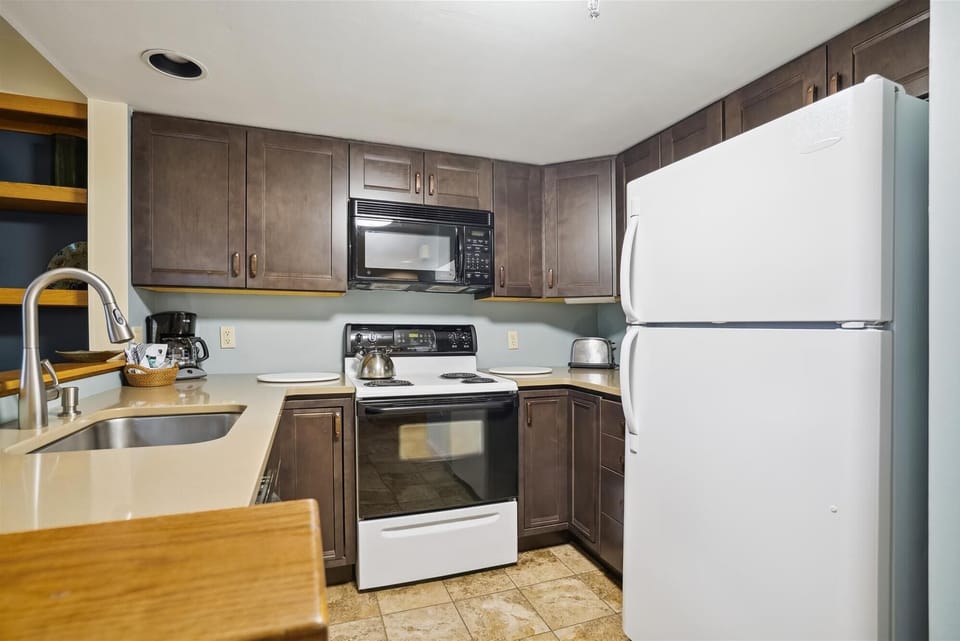 Prepare meals with ease in this functional kitchen complete with full-size appliances and ample storage.