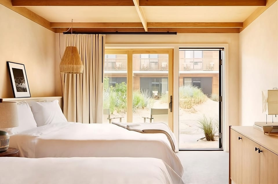Unwind in airy twin-bedroom comfort with sunlit terrace doors.