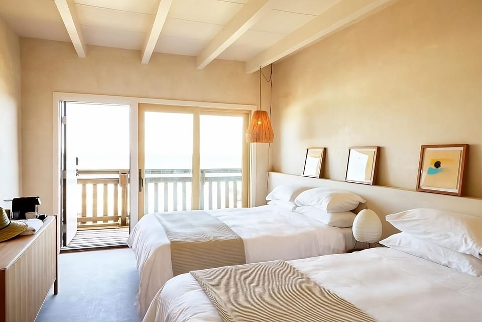 Breathe ocean air from bed with balcony views ahead.