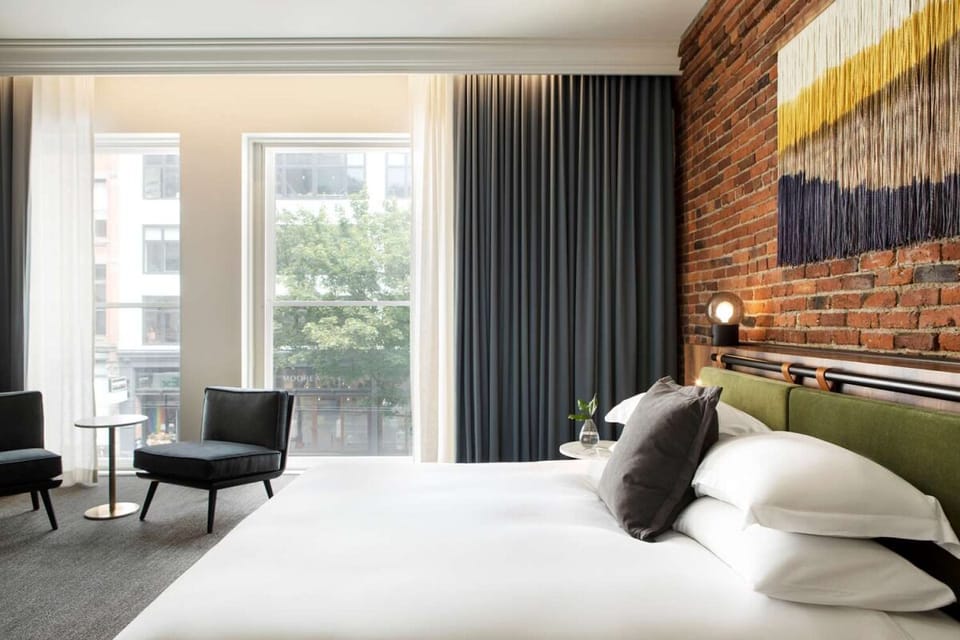Stretch out by sunlit windows beside a warm brick accent wall.