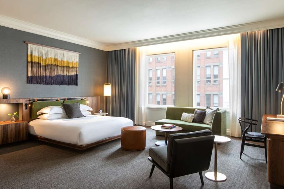 Unwind in a spacious suite with lounge seating and city light.