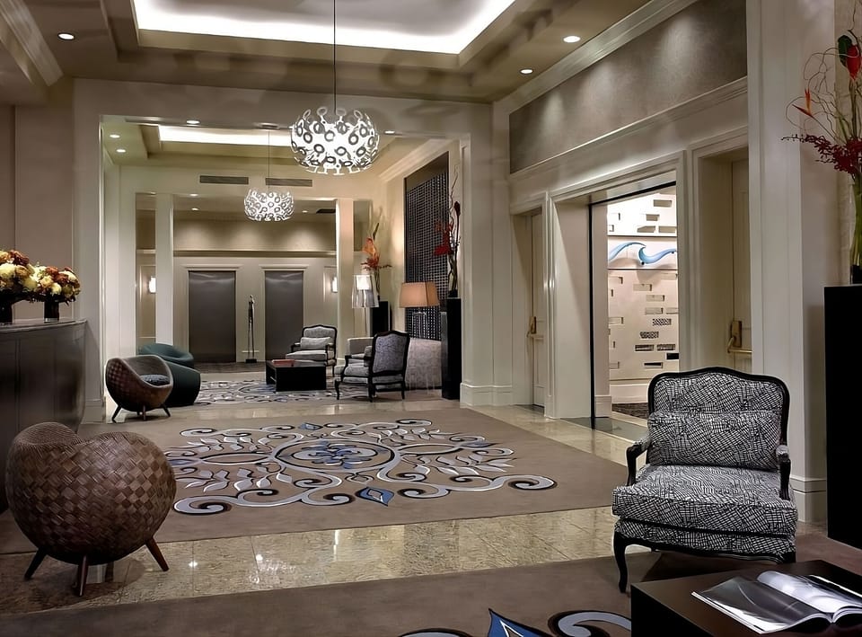 Arrive in style beneath statement lighting and elegant lounge seating.