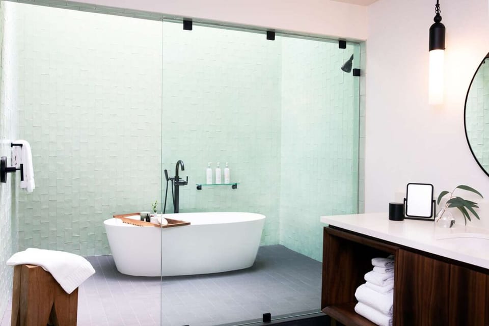 Soak behind glass in a serene, spa-inspired bath retreat.
