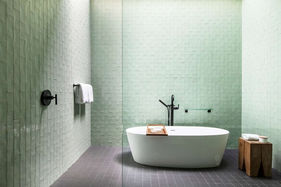 Linger in a deep soaking tub surrounded by tranquil tile.