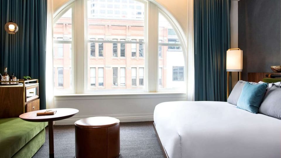 Wake up to city light through the dramatic arched window.