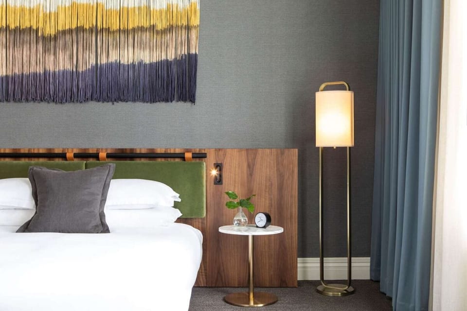 Savor boutique details with artisan wall hanging and soft glow.