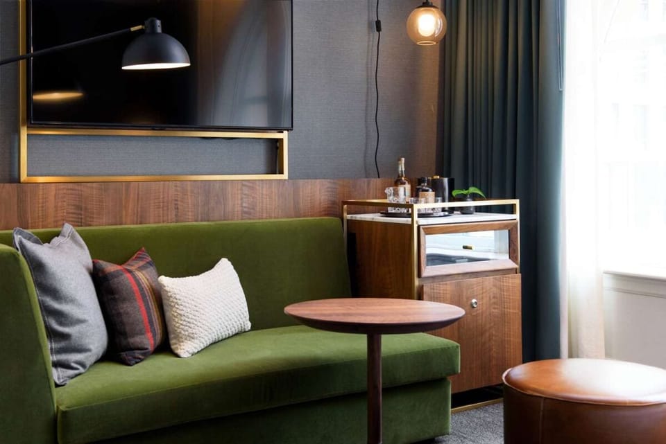 Unwind on the plush sofa with TV and evening glow.