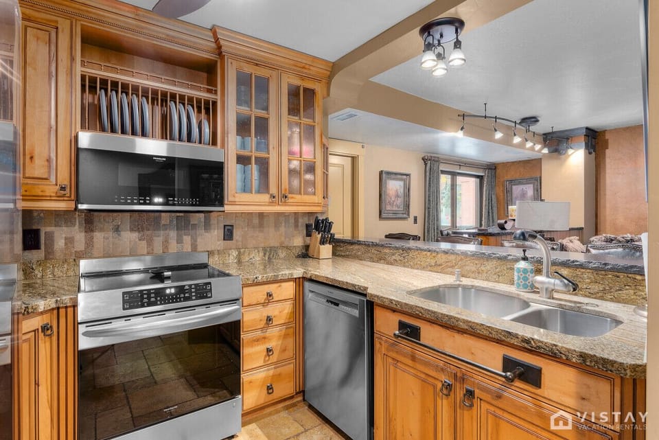 Fully equipped kitchen featuring modern appliances and a coffee maker, ready to meet all your cooking and beverage needs.