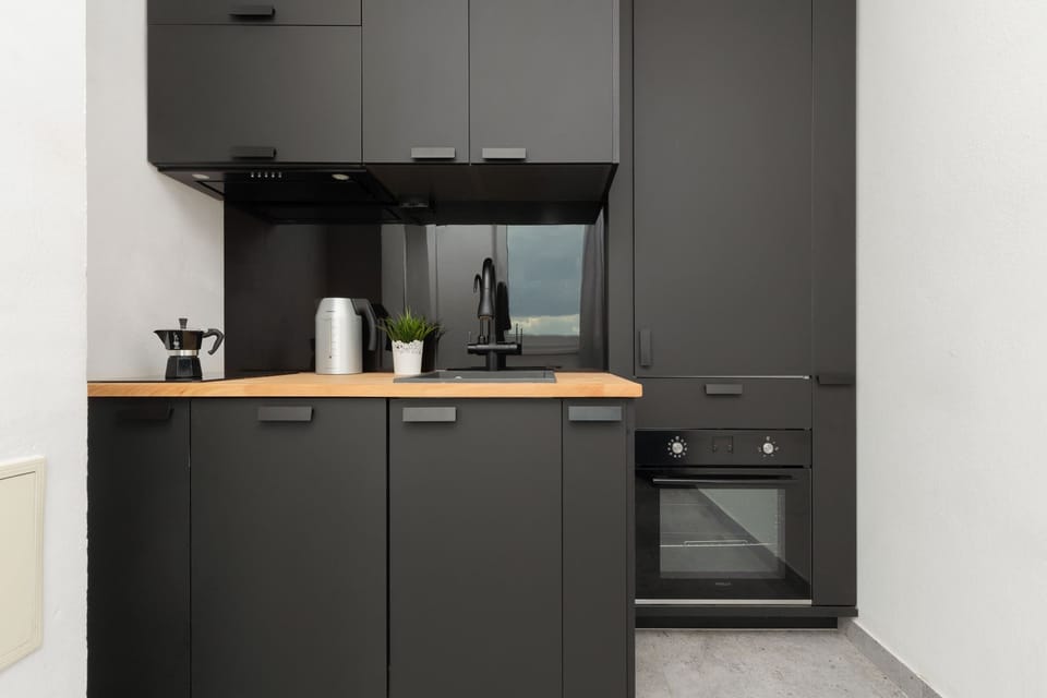 A fully equipped kitchen with dark cabinetry, built-in appliances, and ample counter space for meal preparation.


