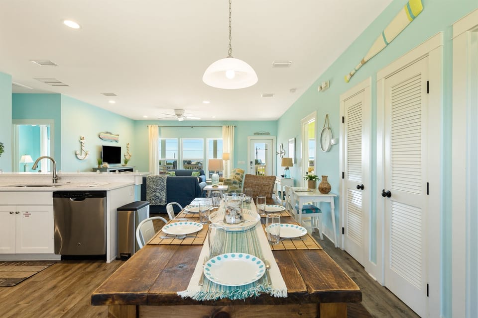 Dining table with bench on one side and chairs on the other side and bar seating. Plenty of seating for your entire family.